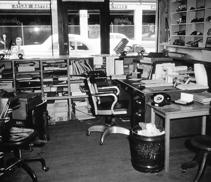 A prototype dump truck sits on the counter. The name Steinke’s appears in the window.