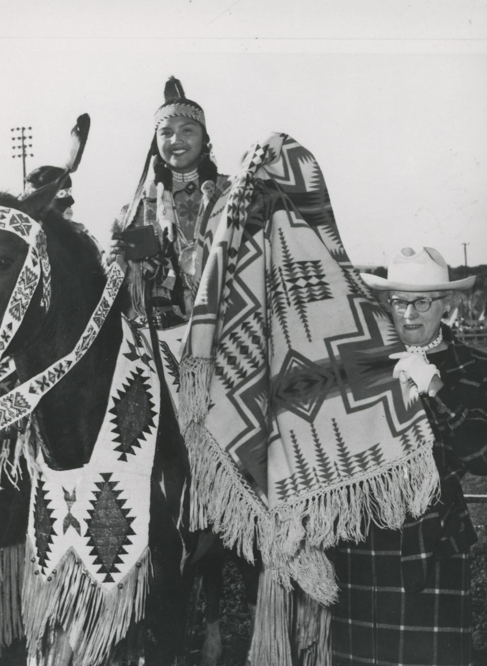 Jean Fell presents the blanket during the American Beauty Contest awards ceremony in Pendleton.