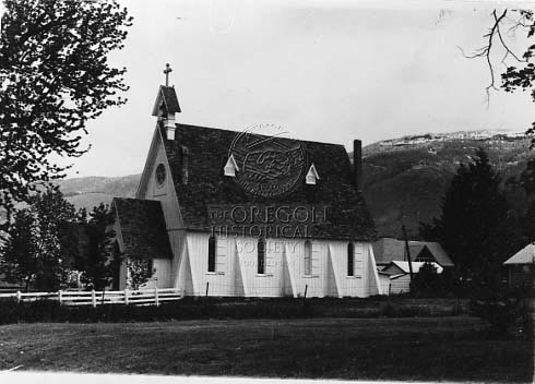 Note enclosed wooden buttresses. Constructed in 1876.