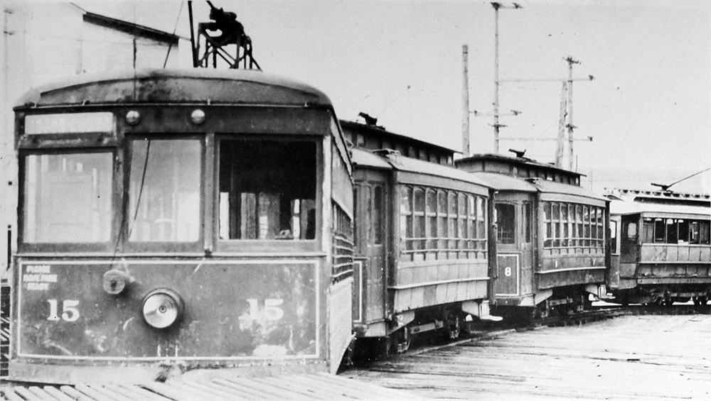Pacific Power and Light Co. trolleys 15, 7, 8, and 5 lined up outside carbarn after Dec. 8, 1922 fire.