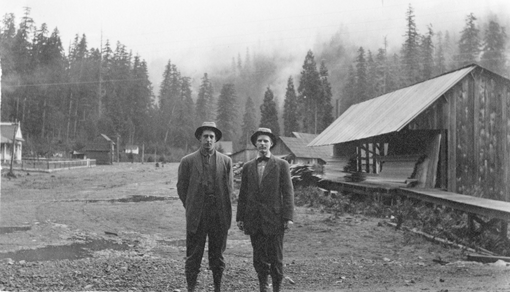 Gold miners Bill Nesmith and C.L. Marshall wait for stage at Blue River, Oct. 1911.