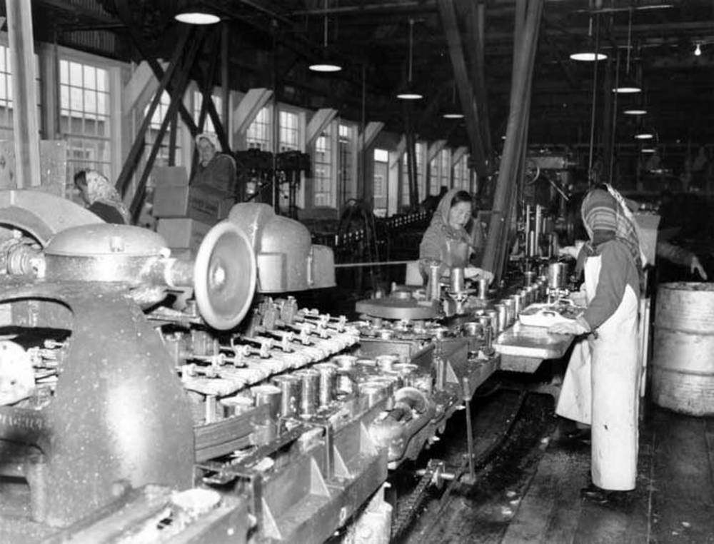 Inspecting canned salmon on final line, CRPA cannery, Naknek, Alaska, 1954.