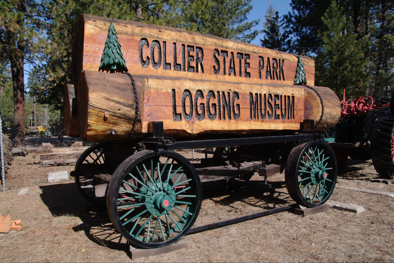 Collier Memorial State Park Logging Museum sign visible from Hwy 97.