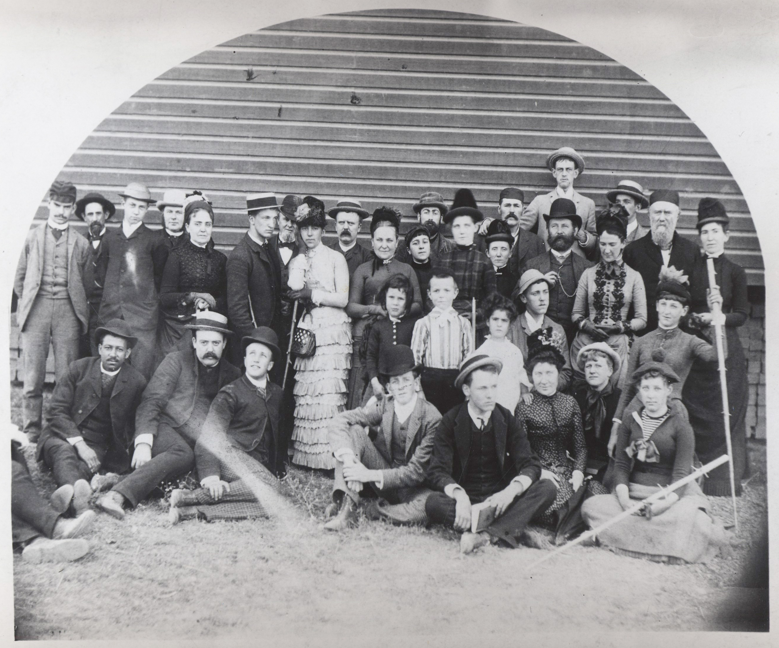 Celebrants of Matthew Deady's birthday, Aug. 1886, Yaquina Bay. Matthew Deady is standing far right with beard and cap.