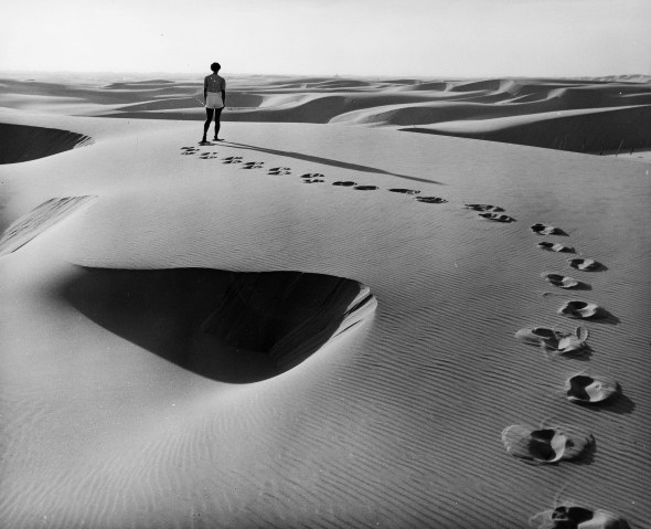 Jane Fitzsimmons walking on sand dunes at the Oregon coast.