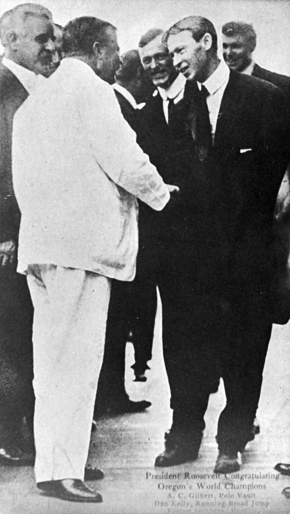 President Theodore Roosevelt shakes hands with 1908 Olympic pole vault champion, A. C. Gilbert.