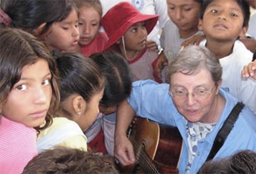 Holy Names Sister Brigid Baumann (with guitar) in Peru.