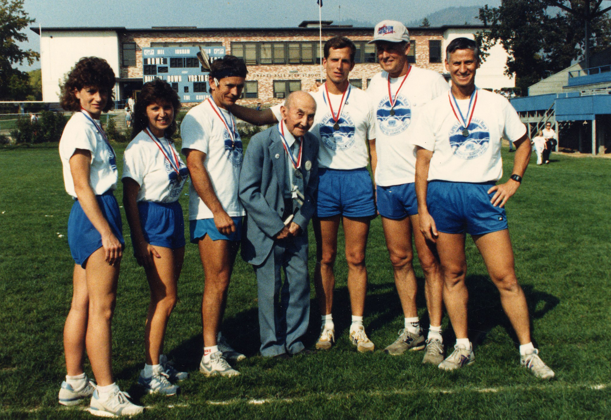 Wayne Morrow (r) and Grants Pass High School runners pose with John Southland (Mad Bull) after 1987 Redwood Empire Indian Marathon, 1987.
