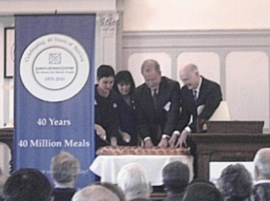 Cutting ceremonial sourdough loaf at Loaves and Fishes 40th anniversary, Feb. 2010.