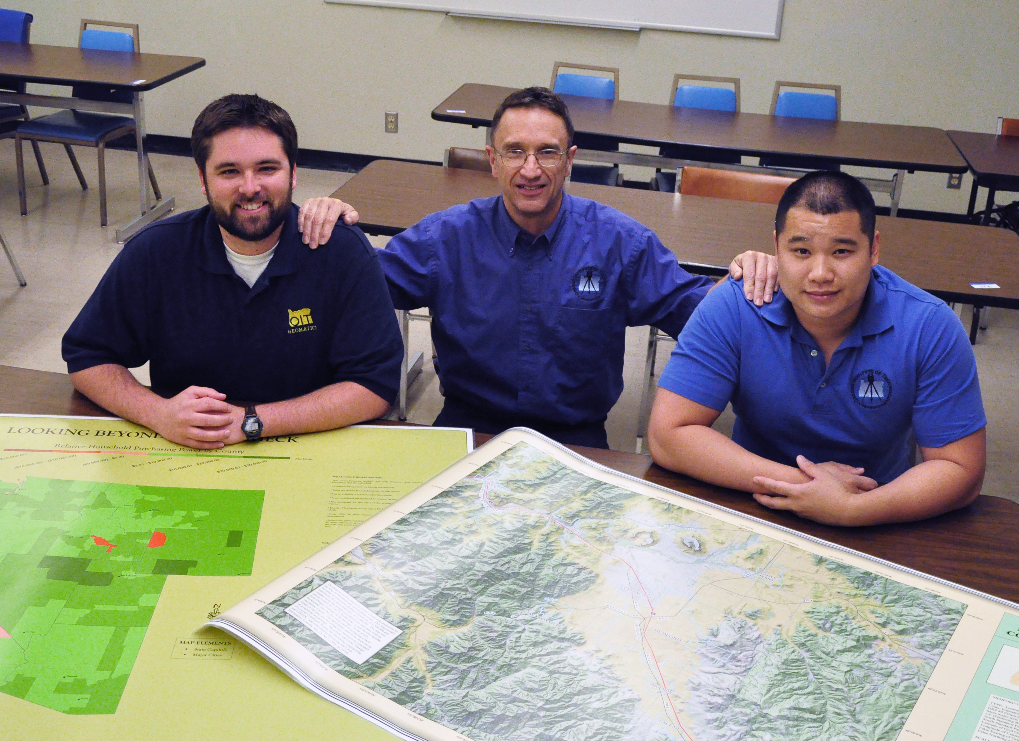 David McIntire (l) and Leo Chan (r) pose with Geomatics Prof. John Ritter and award-winning maps, June 2009.
