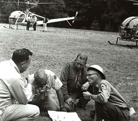 State and federal firefighters consult maps while battling the Oxbow fire, Aug. 1966.