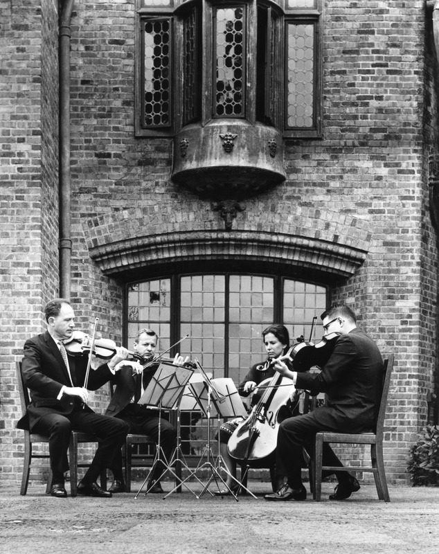 Paul Bellam, Reinhard Pauly, Maria DeRungs, Walter Cogswell performing on Frank Manor House porch.