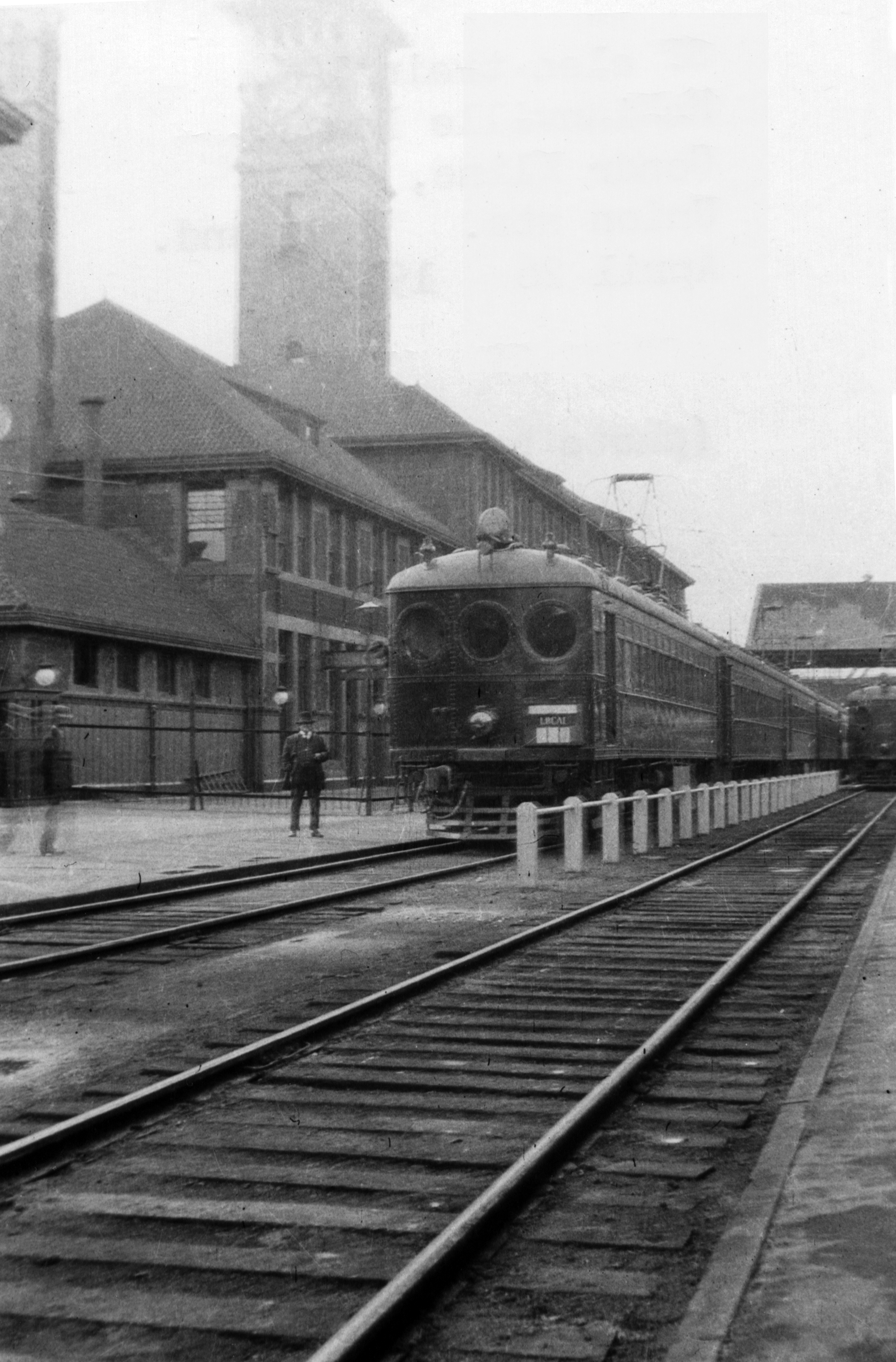 Red Electric Conductor Cline checks watch at Portland's Union Station, 1914.