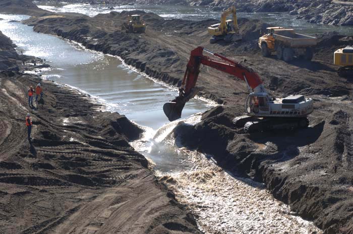 Removing temporary berm to allow the Rogue River to run freely past the dam for the first time in 89 years, Oct. 9, 2009.