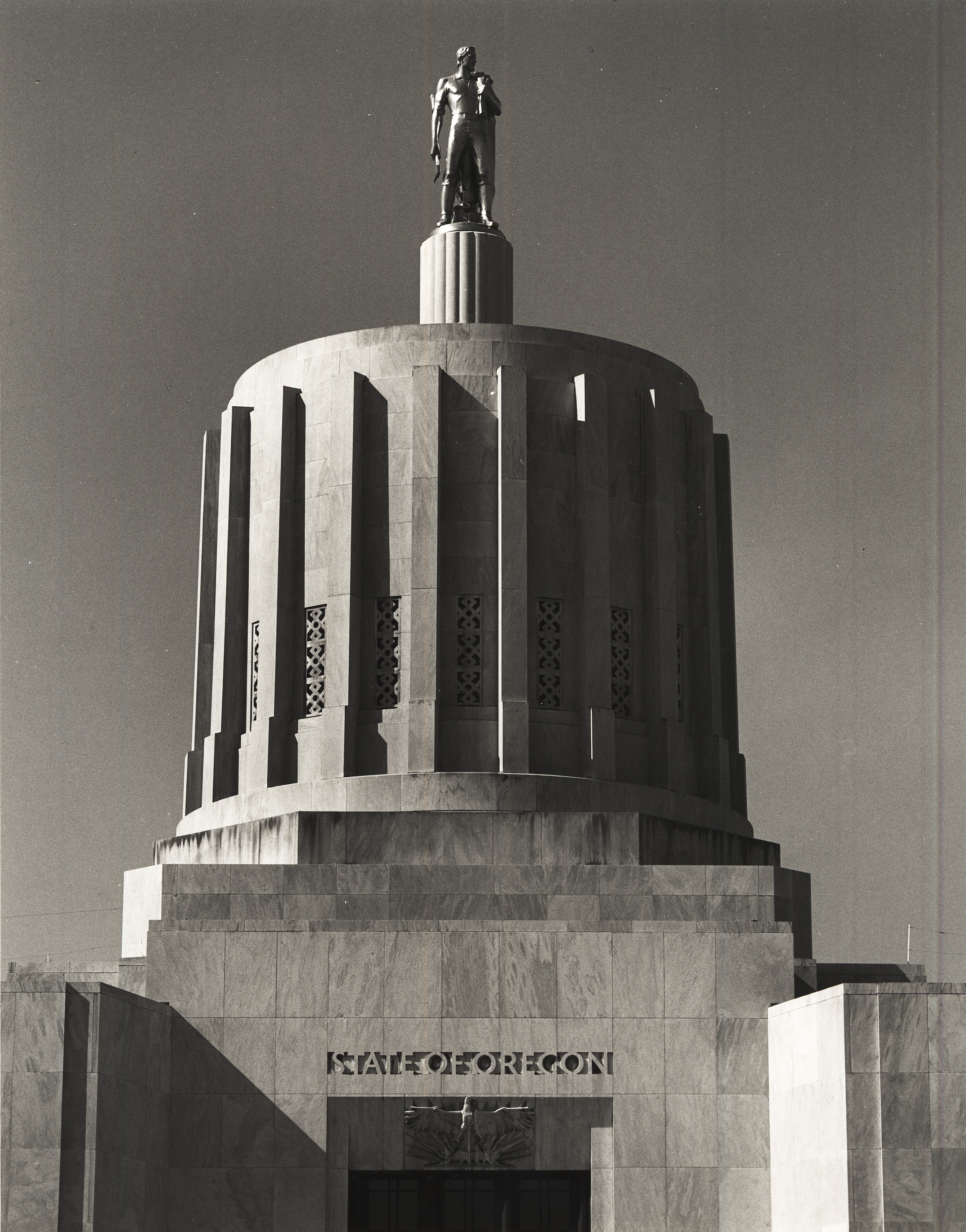 Capitol dome, surmounted by gilded bronze "Pioneer" statute by sculptor Ulric Ellerhusen, with bas relief of eagle over entrance by sculptor Leo Friedlander.