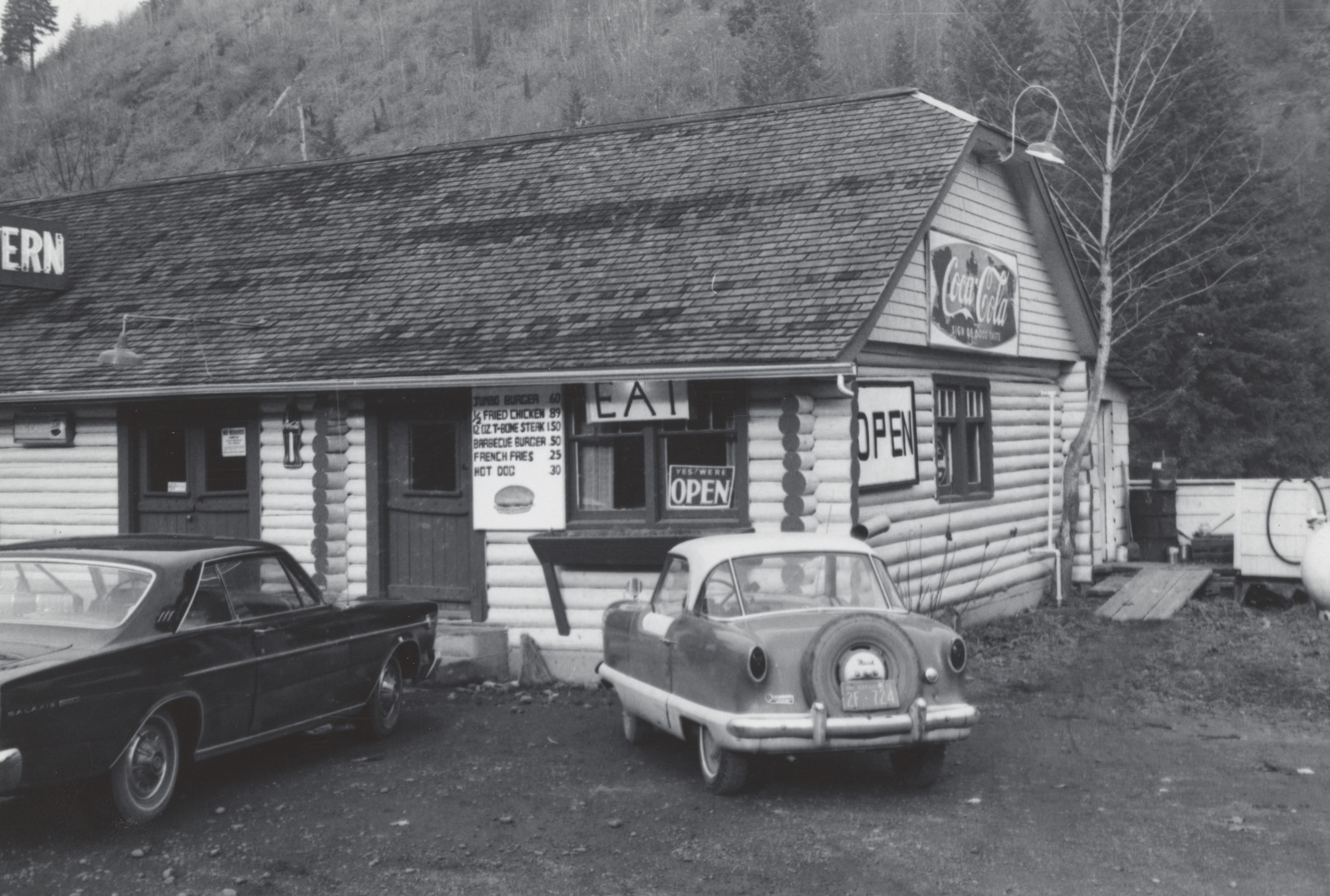 Two cars are parked outside of the Log Cabin Cafe, located between the communities of Glenwood and Gales Creek on Highway 6.