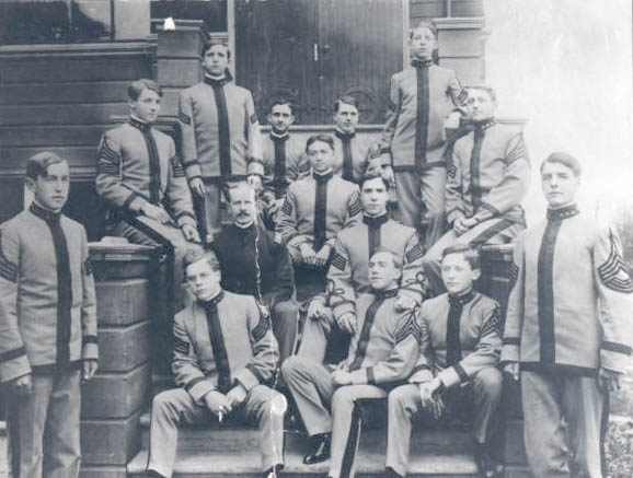 Cadets and teacher on front steps of the academy.
