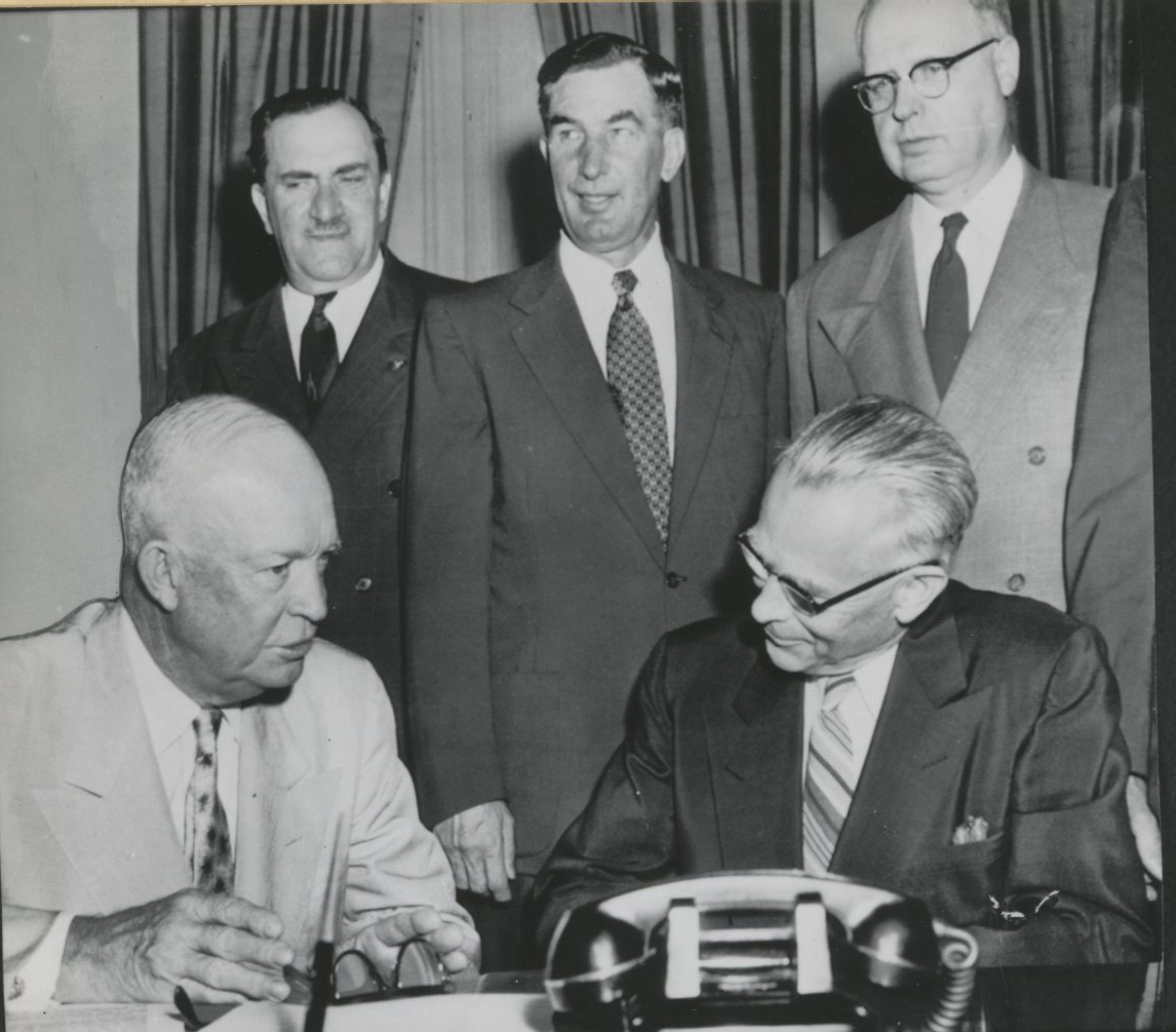 Eisenhower (seated left), Condon (seated right); l-r, Peter Mack, Sam Coon, and M. Harris Ellsworth. 