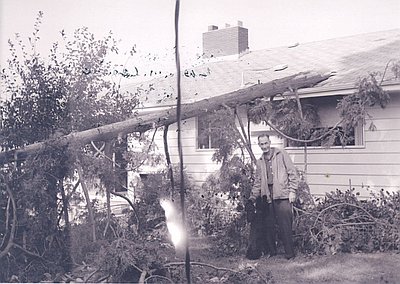 Jim Johnston of Portland stands next to storm damage of his home.