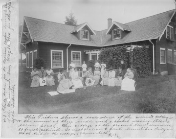 Women patients doing needlework in front of women's cottage, 1915.